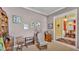 Comfortable living room featuring a rocking chair, neutral walls, and doorway into dining room at 2025 Viewpoint Landings Rd, Lakeland, FL 33810