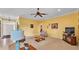 Cozy living room with neutral carpet, yellow walls, and decorative lamps at 2025 Viewpoint Landings Rd, Lakeland, FL 33810