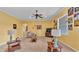 Sunny living room with tile floors, a ceiling fan, and access to other rooms in the house at 2025 Viewpoint Landings Rd, Lakeland, FL 33810