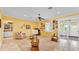 Bright living room featuring tile flooring, yellow walls, and sliding doors at 2025 Viewpoint Landings Rd, Lakeland, FL 33810
