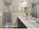Bathroom featuring double sinks, a mirror, and a glass-enclosed shower at 218 Turtle Bay Ave, Winter Haven, FL 33881