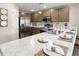 Modern kitchen with stainless steel appliances, wood cabinets, and light countertops at 218 Turtle Bay Ave, Winter Haven, FL 33881