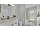 Bathroom with a modern vanity, a shower-tub combination, and a door to the backyard at 2255 Couples Dr, Lakeland, FL 33813