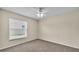 Bright bedroom featuring a window with blinds, neutral carpet, and pale yellow walls at 2255 Couples Dr, Lakeland, FL 33813