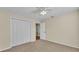 Bedroom featuring carpet flooring, a ceiling fan, closet and a doorway to another room at 2255 Couples Dr, Lakeland, FL 33813