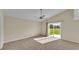 Bedroom with vaulted ceiling, carpet, fan, and large sliding glass door leading to outdoor area at 2255 Couples Dr, Lakeland, FL 33813