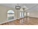 Inviting foyer with wood laminate flooring, modern lighting, and large windows with blinds at 2255 Couples Dr, Lakeland, FL 33813