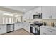 Modern kitchen with white cabinets, stainless steel appliances, and quartz countertops at 2255 Couples Dr, Lakeland, FL 33813