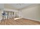 Spacious living room with vaulted ceilings, wood floors, and bright kitchen with bar stool seating at 2255 Couples Dr, Lakeland, FL 33813