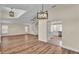 Open-concept living room featuring wood laminate flooring, spiral staircase, and modern light fixtures at 2255 Couples Dr, Lakeland, FL 33813