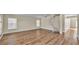 Expansive living area featuring wood laminate floors, a spiral staircase, and bright, natural light at 2255 Couples Dr, Lakeland, FL 33813