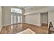 Bright living room with vaulted ceilings, wood floors, French doors, and a large trapezoid window at 2255 Couples Dr, Lakeland, FL 33813