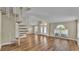 Spacious living area featuring a spiral staircase, wood laminate floors, and ample natural light at 2255 Couples Dr, Lakeland, FL 33813