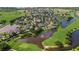 An aerial view of the community highlighting ponds with fountains, a golf course and beautiful single-Gathering homes at 2425 Laurel Glen Dr, Lakeland, FL 33803
