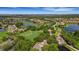 An aerial view of the community featuring a golf course, ponds with fountains, lush trees and beautiful homes at 2425 Laurel Glen Dr, Lakeland, FL 33803