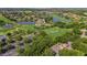 An aerial view of the community featuring multiple ponds with fountains, a golf course, lush trees and beautiful homes at 2425 Laurel Glen Dr, Lakeland, FL 33803