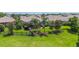 An expansive lawn behind the property features mature trees, landscaping and a black metal fence around the screened lanai at 2425 Laurel Glen Dr, Lakeland, FL 33803