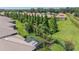Lush backyard featuring mature trees, landscaping, a screened-in lanai and a black metal fence at 2425 Laurel Glen Dr, Lakeland, FL 33803
