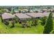 A lush green backyard featuring a screened-in lanai with mature trees, landscaping and a lake view beyond the fence at 2425 Laurel Glen Dr, Lakeland, FL 33803