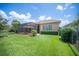 Well-manicured backyard with manicured bushes and a relaxing screened-in patio at 2425 Laurel Glen Dr, Lakeland, FL 33803