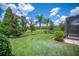 Lush backyard with well-maintained lawn, mature trees, and a black fence at 2425 Laurel Glen Dr, Lakeland, FL 33803