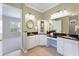 Bathroom with granite countertops, dual sinks, decorative cabinet, and a view of the bedroom at 2425 Laurel Glen Dr, Lakeland, FL 33803