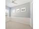 Empty bedroom with neutral colors, two windows with white shutters and a ceiling fan at 2425 Laurel Glen Dr, Lakeland, FL 33803