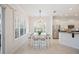 Light filled dining area shows white table and chairs and is adjacent to kitchen at 2425 Laurel Glen Dr, Lakeland, FL 33803