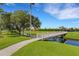 Picturesque foot bridge over a tranquil waterway, enhancing the golf course landscape at 2425 Laurel Glen Dr, Lakeland, FL 33803