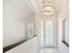 Elegant foyer featuring a decorative chandelier, tiled floors, and a glass paneled front door at 2425 Laurel Glen Dr, Lakeland, FL 33803