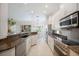 Bright kitchen boasts granite counters, stainless appliances and white cabinetry and lots of natural light at 2425 Laurel Glen Dr, Lakeland, FL 33803