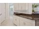 Kitchen features granite counters and white cabinets, with easy access to the adjacent rooms at 2425 Laurel Glen Dr, Lakeland, FL 33803