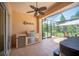 Inviting outdoor kitchen with stainless steel grill, refrigerator, and screened patio views at 2425 Laurel Glen Dr, Lakeland, FL 33803