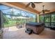 Relaxing screened patio with hot tub, ceiling fan, and outdoor furniture at 2425 Laurel Glen Dr, Lakeland, FL 33803