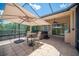 Inviting screened patio with outdoor furniture and view of landscaped backyard at 2425 Laurel Glen Dr, Lakeland, FL 33803