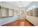 Walk-in closet featuring custom shelves and drawers and wood flooring at 2425 Laurel Glen Dr, Lakeland, FL 33803