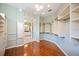 A large walk-in closet with wood floors, custom shelves, and easy access to the bathroom at 2425 Laurel Glen Dr, Lakeland, FL 33803