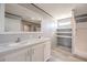 Bathroom featuring double sinks, white cabinets, and a tiled shower at 246 Quail Run, Frostproof, FL 33843