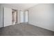 A neutral carpeted bedroom features two doors and neutral walls at 246 Quail Run, Frostproof, FL 33843