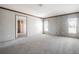 Large carpeted bedroom with natural light from two windows at 246 Quail Run, Frostproof, FL 33843