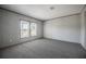 Bedroom with neutral colored walls and carpet, featuring two windows at 246 Quail Run, Frostproof, FL 33843