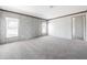 Spacious bedroom featuring neutral carpet, trim, and two bright windows at 246 Quail Run, Frostproof, FL 33843