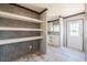 Bright entryway boasting wood-look floors and built in shelving and a white front door at 246 Quail Run, Frostproof, FL 33843