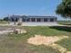 Exterior of a single-story home with siding and a wood porch and rural setting at 246 Quail Run, Frostproof, FL 33843