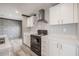 View of kitchen featuring white cabinets, and black appliances at 246 Quail Run, Frostproof, FL 33843