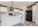 View of kitchen featuring white cabinets, island and black appliances at 246 Quail Run, Frostproof, FL 33843