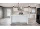 Open kitchen with a center island, bar stool seating and stainless steel appliances at 246 Quail Run, Frostproof, FL 33843