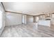 Open-concept living room featuring light, plank flooring and neutral walls at 246 Quail Run, Frostproof, FL 33843