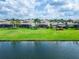 A beautiful lake view from the backyard with a large grassy area and mature landscaping at 2464 Laurel Glen Dr, Lakeland, FL 33803