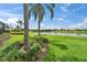 Serene backyard with lush landscaping and water view at 2464 Laurel Glen Dr, Lakeland, FL 33803